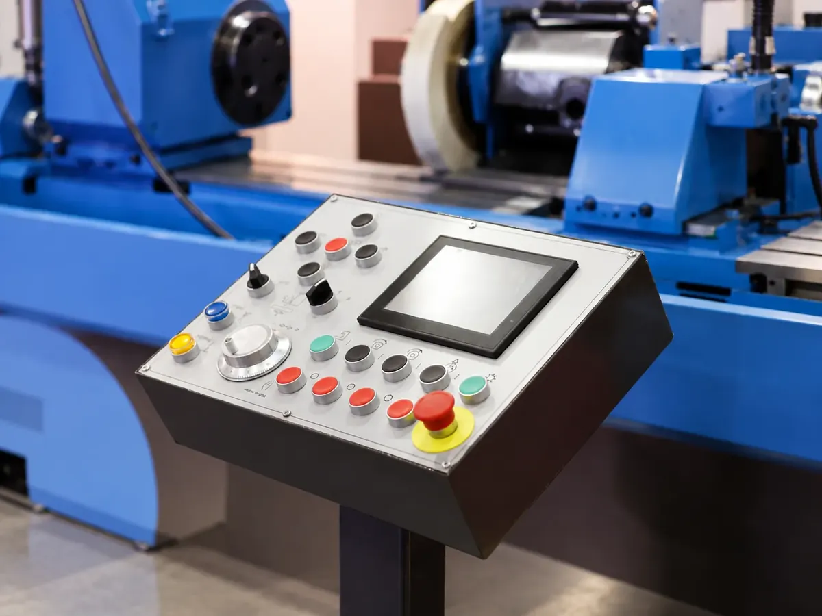 Machine-mounted control panel with touchscreen, buttons and emergency stop